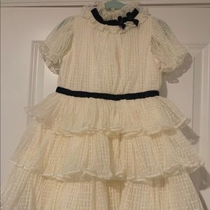 Cream Three-Tiered Dress with Navy Trim on the neck and waist.